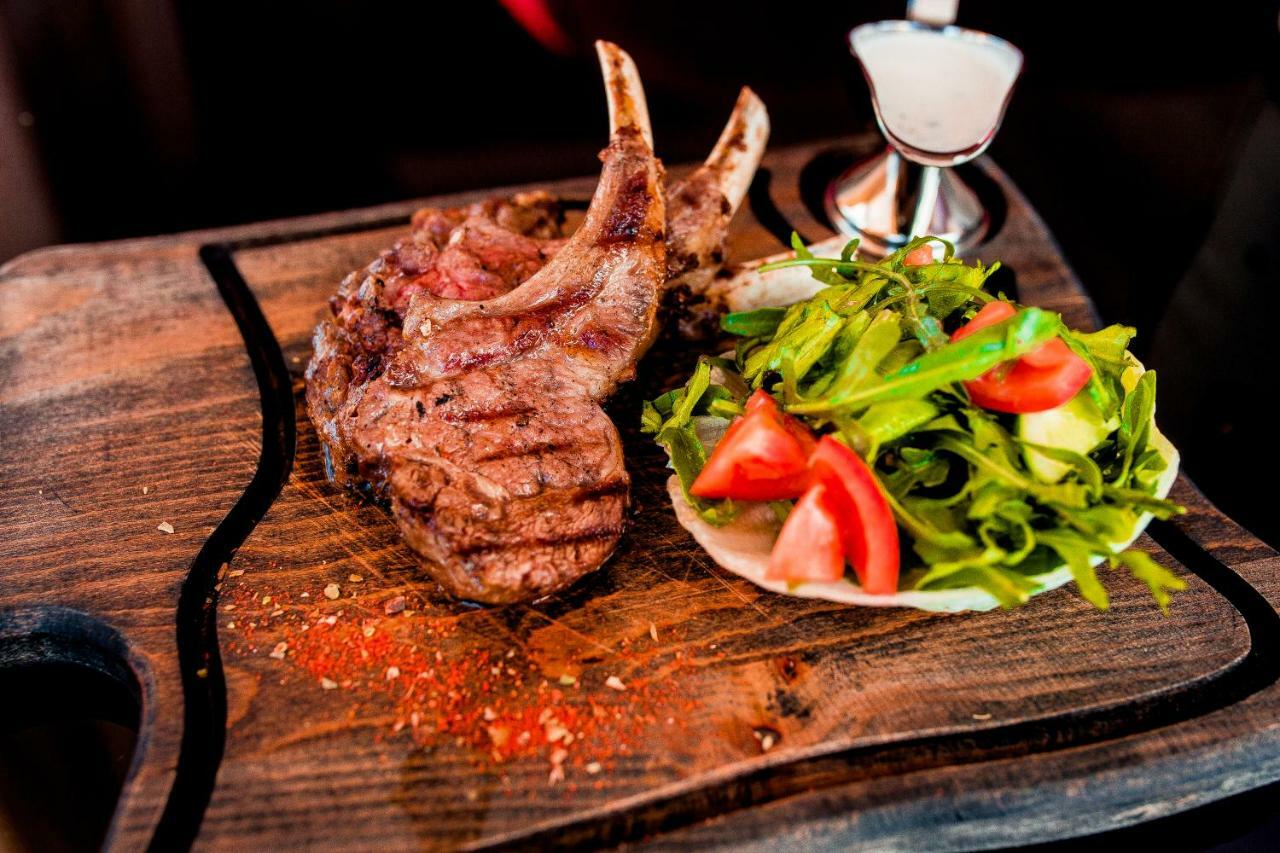 Caspian Riviera Grand Palace Hotel Aktau  Exterior photo A grilled lamb chop with a fresh salad